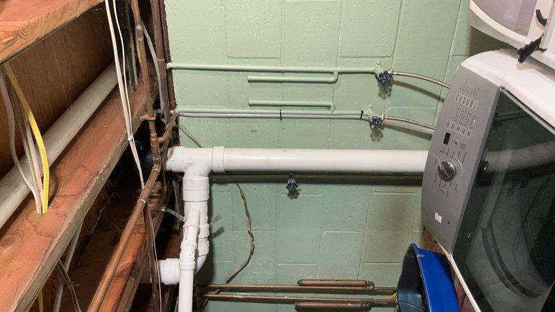 Removed deteriorated cast iron drain piping from 24 inches above floor level to the toilet riser and tied into the existing vertical stack. Replaced the bathtub drain line with new PVC piping, installed a new closet flange, and reset the toilet to proper working condition. All work included floor protection measures and replacement of the vertical drain stack to ensure proper drainage function.