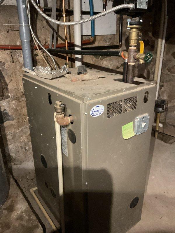 Responded to service call for outdoor central boiler reported as not working. Performed comprehensive system inspection of both the outdoor wood-fired boiler and indoor gas boiler. Verified outdoor wood boiler damper assembly and mechanical components are functioning properly; unable to confirm full operational status without firing unit. Inspected indoor gas boiler, confirmed system appears operational with all visible components, pressure gauge, gas valve assembly, and piping connections in working order. Verified circulating pump was operational during previous heating season per customer report. Primary issue identified relates to underground electrical wire supply to outdoor boiler unit requiring electrical contractor assessment. Provided customer education on system operation and component functions for both heating systems. Documented equipment condition with photographs for insurance claim purposes related to electrical service failure.