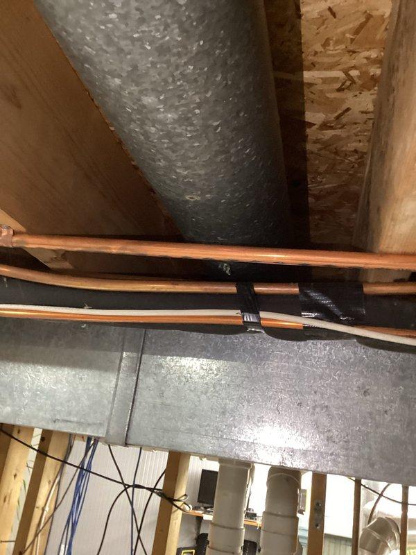 Responded to service call for poor airflow throughout residence, with significant airflow deficiencies reported upstairs and inconsistent distribution between rooms. Performed comprehensive inspection of existing ductwork system, including flexible HVAC ducts, rigid galvanized metal supply lines, and support infrastructure in basement and attic spaces. Documented current ductwork configuration, noting flexible duct routing, copper refrigerant line placement, and overall system layout to assess airflow restriction points and identify opportunities for improved air distribution and system performance.