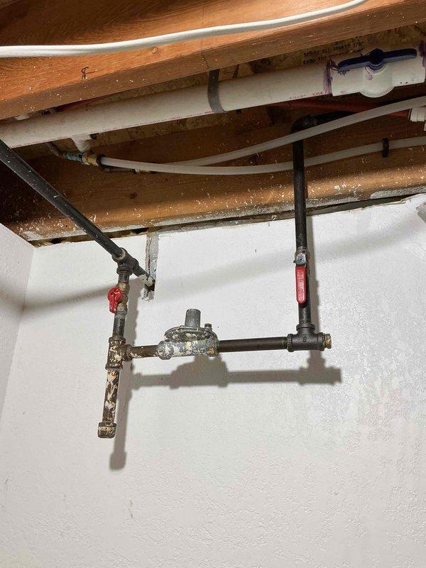 Returned for follow-up on previously reported gas odor, which persisted in a different area of the home. Used electronic gas detection equipment to locate the source and identified two leaking fittings on the gas drip leg assembly in the downstairs closet. Disassembled the affected fittings, resealed connections with appropriate pipe compound, and reassembled the drip leg. Conducted thorough leak testing of the repaired gas line connections and confirmed all leaks were eliminated with no further gas detection present.