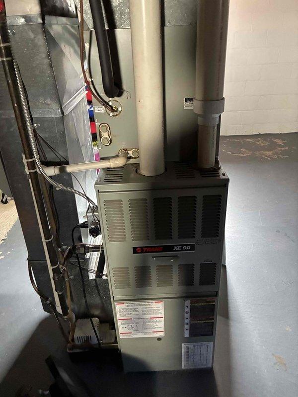 Completed preventive maintenance on a 30-year-old Trane XE90 furnace. System was found operating within normal parameters with heat exchanger in acceptable condition. Noted previous non-standard control board modification by unknown technician, though unit continues to function properly. Discussed equipment age and recommended considering system replacement due to advanced age of unit.