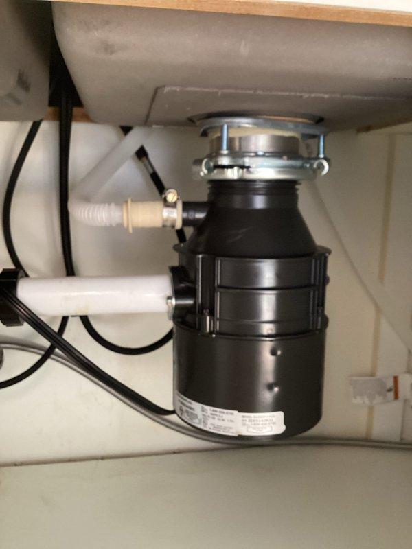 Responded to service call for malfunctioning garbage disposal. Upon inspection, found unit seized with corroded internal components rendering it inoperable. Removed existing disposal unit and installed new Badger 500 model (1.5 HP, 6.3 amp) garbage disposal. Connected discharge plumbing to existing P-trap assembly, secured dishwasher drain line connection, and completed electrical wiring. Tested unit for proper operation and verified no leaks at mounting flange or discharge connections.