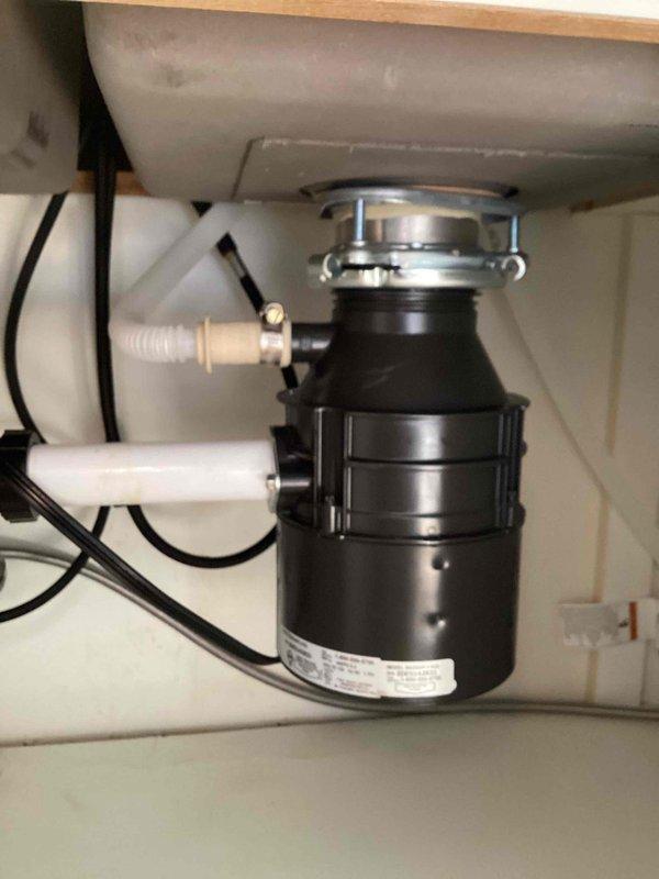 Responded to service call for malfunctioning garbage disposal. Upon inspection, found unit seized with corroded internal components rendering it inoperable. Removed existing disposal unit and installed new Badger 500 model (1.5 HP, 6.3 amp) garbage disposal. Connected discharge plumbing to existing P-trap assembly, secured dishwasher drain line connection, and completed electrical wiring. Tested unit for proper operation and verified no leaks at mounting flange or discharge connections.