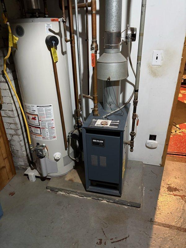Performed pre-winter tune-up and comprehensive inspection on 20+ year old Weil McLain boiler system. Inspected all piping connections, backflow preventer, and pressure relief valve—all found in good working condition with no leaks detected. Cleaned burner cavity and burners to address customer concern regarding orange pilot flame. Verified proper operation of all electronic controls and circulator pump.

During detailed inspection, identified heavily scaled heat exchanger affecting combustion efficiency. Conducted combustion analysis which revealed elevated carbon monoxide levels in flue gases, consistent with heat exchanger deterioration. Detected 12 ppm CO emission from lower left seal area. Given the age of the equipment and severity of heat exchanger scaling combined with elevated CO readings, discussed replacement options with homeowner and scheduled follow-up consultation with service advisor to review equipment upgrade recommendations and ensure safe, efficient heating operation