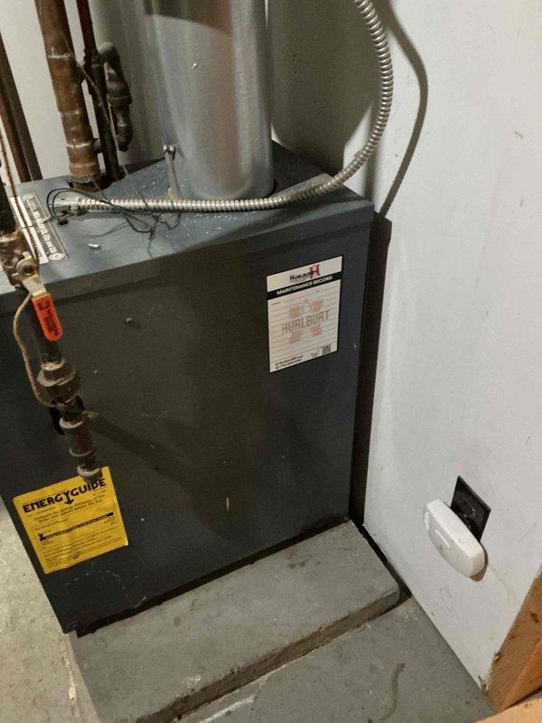 Performed pre-winter tune-up and comprehensive inspection on 20+ year old Weil McLain boiler system. Inspected all piping connections, backflow preventer, and pressure relief valve—all found in good working condition with no leaks detected. Cleaned burner cavity and burners to address customer concern regarding orange pilot flame. Verified proper operation of all electronic controls and circulator pump.

During detailed inspection, identified heavily scaled heat exchanger affecting combustion efficiency. Conducted combustion analysis which revealed elevated carbon monoxide levels in flue gases, consistent with heat exchanger deterioration. Detected 12 ppm CO emission from lower left seal area. Given the age of the equipment and severity of heat exchanger scaling combined with elevated CO readings, discussed replacement options with homeowner and scheduled follow-up consultation with service advisor to review equipment upgrade recommendations and ensure safe, efficient heating operation