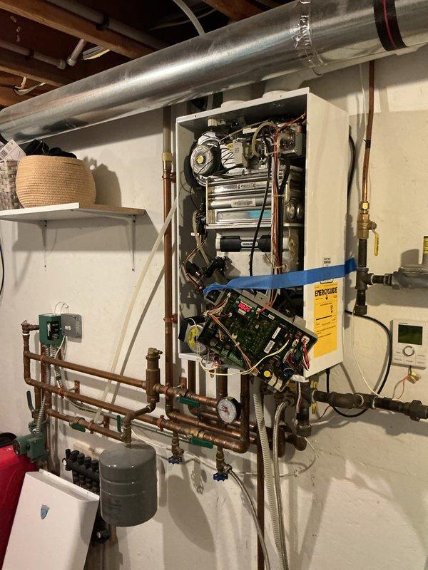 Responded to no hot water call and diagnosed Navien tankless water heater displaying error code 16, indicating overheating condition. Upon inspection, determined unit is an older model no longer under warranty with new homeowner. Provided estimates for repair options and discussed replacement alternatives. Customer elected to self-install a traditional tank-style water heater as replacement solution.