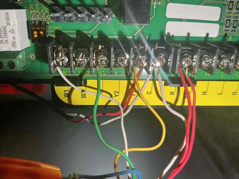Completed warranty control board replacement on HVAC system. Upon initial installation, unit failed to operate properly due to incorrectly configured dip switch settings on the new control board. Returned to site, diagnosed dip switch configuration error, and corrected all switch positions per manufacturer specifications. Verified all wire terminations at terminal block including W, W1, C, R, H, and O connections. System tested and confirmed operational following proper dip switch configuration.