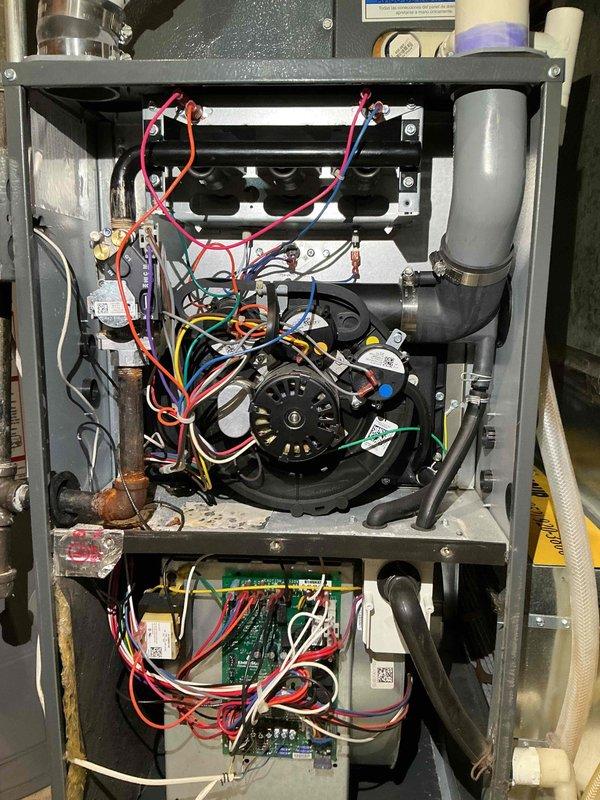 Responded to no heat call on Amana furnace. Upon arrival, unit was heating intermittently but flames would extinguish during operation. Performed initial maintenance including cleaning burners and flame rod. During diagnostic testing, identified pressure switch malfunction caused by condensate drainage blockage. Cleared obstruction in drain line leading to condensate pump, restoring proper water flow. Thoroughly cleaned all condensate drain lines including trap assembly connected to inducer motor, pressure switch tubing, and pump inlet. Cycled unit multiple times to verify consistent ignition and flame stability. System restored to normal heating operation with pressure switch functioning correctly after drainage system was cleared.