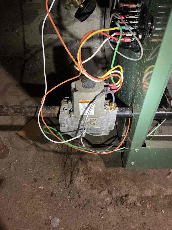 Responded to no heat call on 25-year-old New Yorker boiler. Diagnosed failed ignition assembly flame sensor. Cross-referenced and installed compatible Weil McLain ignition assembly from stock. Replaced outdated ignition module with Honeywell module to ensure compatibility with new flame sensor. System successfully fired upon completion of repairs. Performed combustion analysis which revealed elevated CO levels in flue gases. Identified CO leakage from deteriorating lower left seal. Conducted borescope inspection of heat exchanger, revealing signs of deterioration consistent with age and condition of unit. High CO readings likely attributed to compromised heat exchanger integrity. Restored heat to residence and reviewed repair options and system replacement considerations with homeowner due to safety concerns and age of equipment.