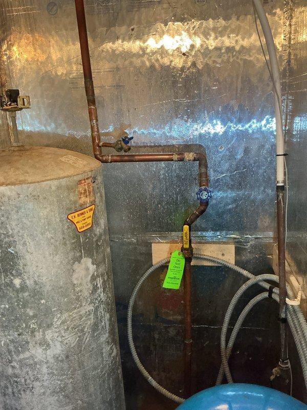Responded to water leak at washing machine supply lines. Upon inspection, found corroded copper piping showing significant oxidation feeding the washing machine connection. Tested shut-off valve at washing machine location and confirmed proper operation despite surface oxidation present. Leak originated from deteriorated copper supply lines due to age and corrosion. Documented existing conditions including water-damaged walls, aging plumbing infrastructure, and compromised copper piping throughout the utility area. Provided estimate for complete repipe and replacement of corroded washing machine supply lines.