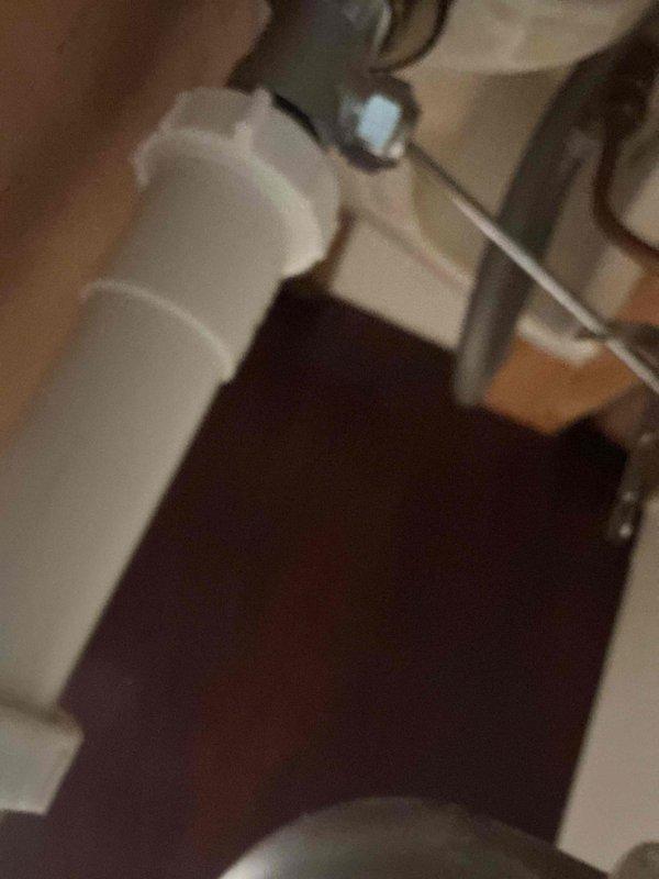 Responded to a bathroom sink leak caused by a failed slip joint nut and washer on the drain trap assembly. Removed the deteriorated components and installed new slip joint nut and washer to restore proper seal and eliminate the leak. Verified system integrity and confirmed no further water discharge from the trap connection.