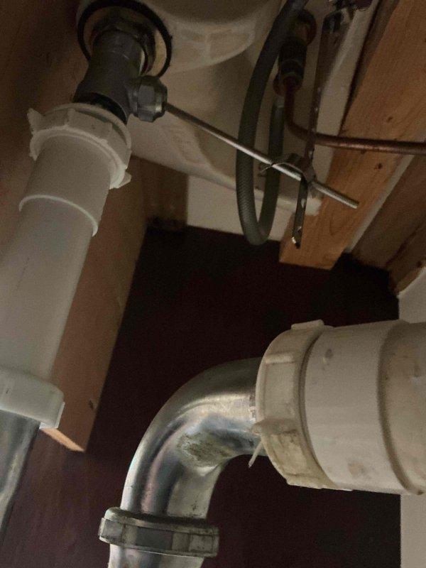 Responded to a bathroom sink leak caused by a failed slip joint nut and washer on the drain trap assembly. Removed the deteriorated components and installed new slip joint nut and washer to restore proper seal and eliminate the leak. Verified system integrity and confirmed no further water discharge from the trap connection.