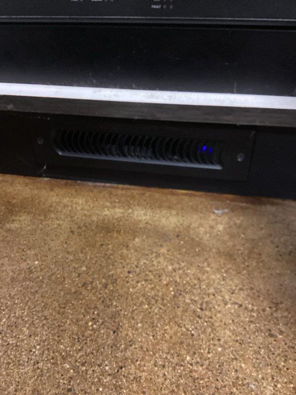 Responded to service call for reported constant screeching noise initially suspected to be from HVAC unit. Upon inspection, determined the noise was not originating from the HVAC system but from a cooling/ventilation fan within an AV equipment cabinet located beneath the countertop. The cabinet houses multiple electronic media components in a rack-mounted configuration with associated networking and power connections. No HVAC repairs were necessary as the unit was operating normally without abnormal sounds.