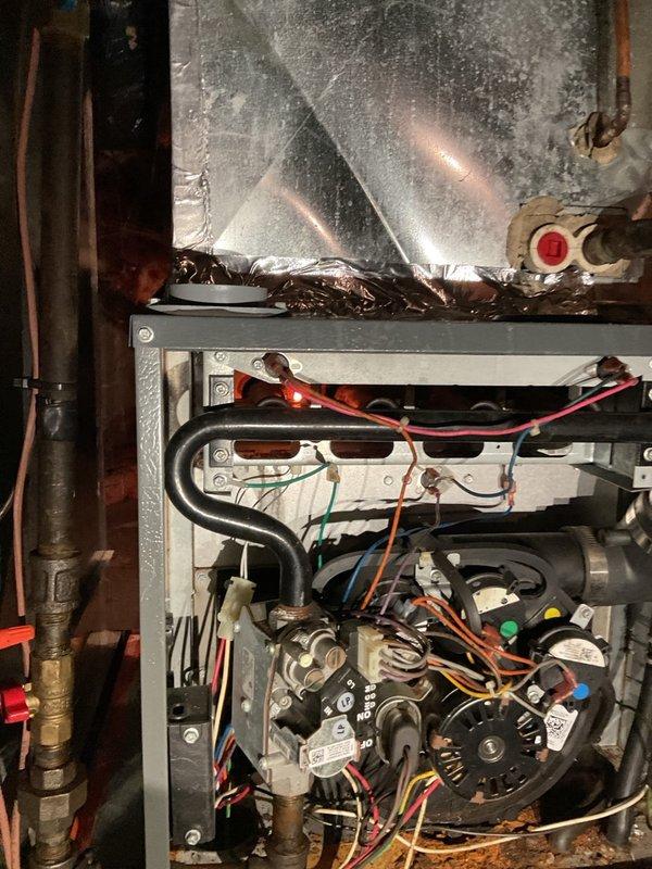 Completed winter tune-up on a 13-15 year old Daikin furnace that was operating properly with no reported issues at time of service. During maintenance inspection, discovered severe burner and heat exchanger deck corrosion caused by excessive moisture exposure from the unconditioned crawlspace combined with the furnace drawing combustion air from the indoor space. Documented the advanced corrosion with photographs showing deteriorated burner assembly components and compromised internal surfaces, and advised homeowner of the safety concerns and need for professional consultation regarding system replacement options.