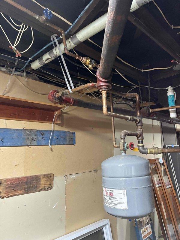 Installed backflow preventer on boiler system that was already equipped with filltrol fitting and autofill tank. Piped in the backflow preventer assembly using copper connections, verified all joints for water-tightness, and adjusted boiler system pressure to proper operating specifications. System is now operational and ready for inspection.