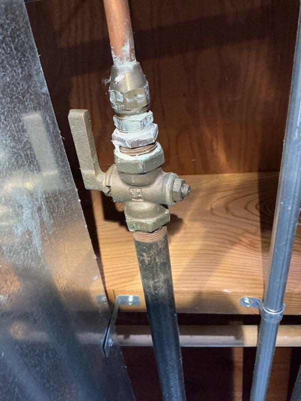 Performed on-site assessment of gas range installation that was rejected by appliance installer due to code compliance issues. Evaluated existing gas line configuration and determined that installation of a shut-off valve and drip-leg (sediment trap) is required to meet current code standards for gas appliance connection. Documented existing copper and black iron pipe configuration with photographs for office review and estimate preparation.