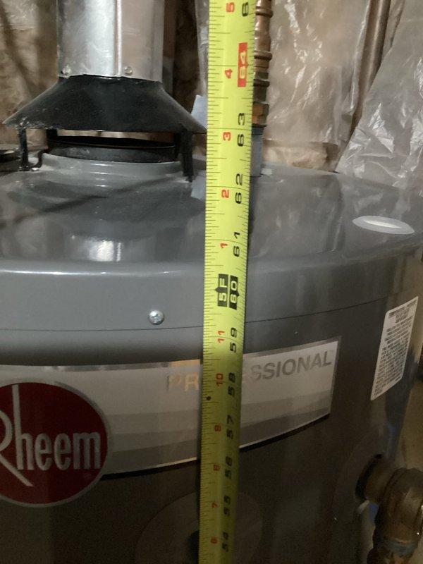 Responded to service call for leaking water heater. Upon inspection, confirmed active leak originating from the tank itself, with water present inside the unit's jacket. Conducted thorough assessment of the Rheem Professional series water heater and documented measurements and leak location with photographic evidence. Prepared comprehensive replacement estimate due to tank failure, as internal tank leaks are not repairable and require full unit replacement.