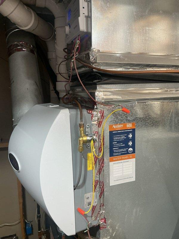 Installed AprilAire 600 humidifier and 16x25 electronic air cleaner to existing HVAC ductwork system. Wired humidifier control (Model 60) for automatic operation with heat-only activation, removing previous humidistat wiring. Completed installation with full system testing to verify proper operation of both humidifier and air cleaner units.