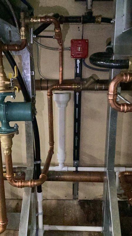 Completed inspection callback on commercial boiler system to address faulty pressure relief valves. Removed existing pressure relief valve and relocated to improved position for proper operation and code compliance. Installed new copper piping with soldered joints and brass fittings to connect relief valve discharge to building drain system via indirect waste connection, ensuring safe discharge of water in the event of overpressure conditions. All work completed per applicable plumbing and mechanical codes.