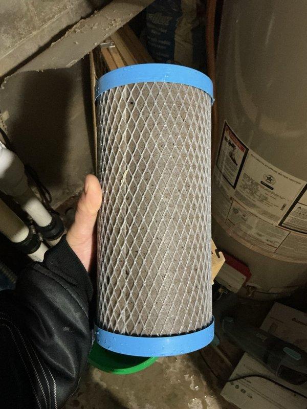 Responded to service call for low water pressure throughout residence where customer reported inability to use two faucets simultaneously. Upon arrival, conducted comprehensive inspection of all above-ground well equipment and confirmed all components were in good working condition and functioning normally. 

Identified whole house water filter as potential cause of pressure restriction. Removed and inspected filter cartridge, which appeared relatively clean visually but exhibited extremely dense filtration media that was significantly restricting water flow. Performed diagnostic test by running water supply with filter housing bypassed, which immediately restored normal water pressure throughout all fixtures in the home.

Evaluated property specifications, noting two-story structure with three full bathrooms supplied by 3/4-inch copper supply line. Determined that existing filter's micron rating was too restrictive for the home's plumbing configuration and water demand requirements. P