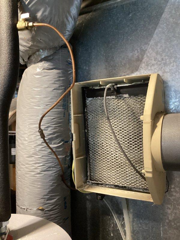 Completed comprehensive tune-up and safety inspection on a 13-year-old Bryant high-efficiency gas furnace. Performed full maintenance protocol including assessment of all system components, heat exchanger inspection, burner assembly cleaning, and verification of operational parameters. System found to be functioning within normal specifications with age-appropriate wear and tear noted. Identified leaking humidifier unit requiring replacement to maintain optimal indoor air quality and prevent water damage. Inspected copper refrigerant lines, brass valve fittings, and ductwork connections in attic installation area. Verified proper airflow through air handling unit and confirmed mesh filter condition. All safety controls tested and confirmed operational. System running effectively and ready for heating season operation.