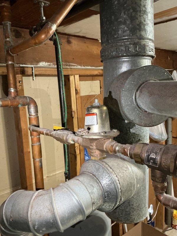 Responded to service call for boiler system experiencing low water pressure and inability to reach required operating pressure. Upon inspection, diagnosed faulty automatic fill valve preventing proper system pressurization. Verified boiler water level insufficient for safe operation and confirmed autofill mechanism failure as primary cause. Documented existing plumbing configuration including copper supply lines, pressure relief components, and ventilation ductwork. Recommended and sold replacement with bell-style automatic fill valve to restore proper water feed functionality. Scheduled follow-up appointment to complete installation of new autofill valve and restore boiler to normal operating parameters.