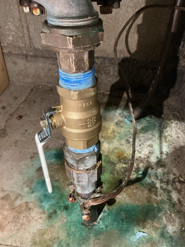 Responded to service call for water shut-off valve inspection prior to city water meter replacement. Upon initial assessment, determined existing shut-off valve required replacement due to age and condition. Returned to property to install new brass shut-off valve on main water supply line. Completed installation with proper threading and sealing, ensuring leak-free operation. Noted evidence of previous copper corrosion and mineral deposits on basement floor beneath plumbing assembly, indicating historical moisture exposure. Verified proper valve function and confirmed system integrity following installation.
