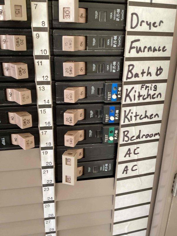Conducted phone follow-up regarding refrigerator circuit breaker that continues to trip. Confirmed new breaker has been ordered and scheduled installation for the following day. Documented electrical panel configuration with photos showing circuit identification labels and breaker positions for refrigerator circuit.