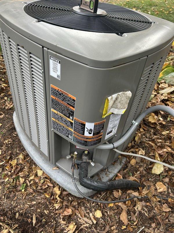Responded to service call for recently installed outdoor condenser unit experiencing instability due to unstable ground conditions and deteriorated wooden support base. Leveled and prepared ground surface, installed 4x4 plywood base, and positioned 1" landscape pavers to create stable, level foundation for condenser unit. Verified unit was properly leveled and balanced on new paver support system to prevent future settling and ensure optimal equipment operation.