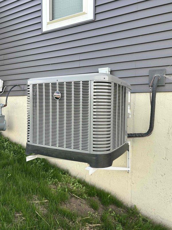 Completed annual preventive maintenance on both air conditioning and furnace systems for a one-year-old residential HVAC installation. Performed comprehensive system tune-up including inspection of outdoor condenser unit mounted on exterior wall bracket, verified proper operation of all components, checked refrigerant lines and electrical connections, and conducted full operational testing of both heating and cooling equipment. All systems found to be functioning properly with no issues identified during inspection.