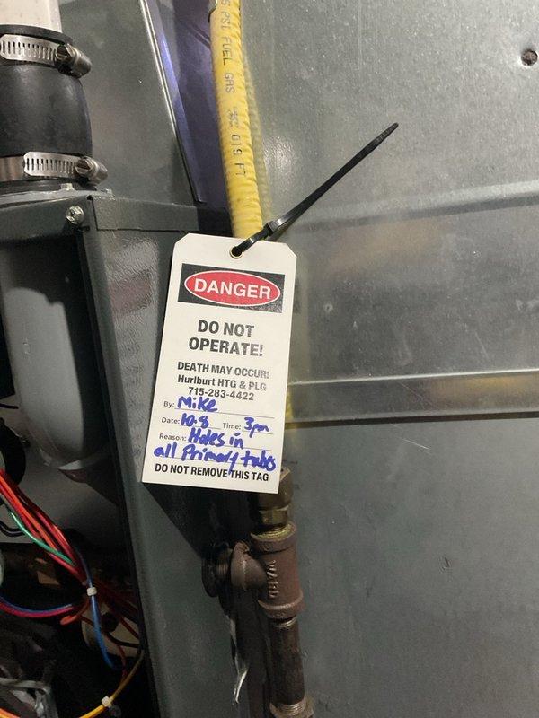 Responded to no-heat call on 20-year-old furnace system. Customer had attempted DIY thermostat replacement which resulted in blown 3-amp fuse on control board. Located spare fuse inside furnace cabinet and replaced blown fuse to restore low-voltage control circuit. Upon further inspection, discovered multiple holes in heat exchanger tabs, creating unsafe operating condition with potential for carbon monoxide exposure. Immediately red-tagged furnace and placed "DANGER - DO NOT OPERATE" lockout tag on unit due to failed heat exchanger. System shut down for safety until replacement can be scheduled. Customer also requested pricing for air conditioning system replacement. Documented compromised ductwork showing signs of age-related deterioration and possible moisture damage in attic space. Recommended complete system replacement given age of equipment and critical safety failure of heat exchanger.