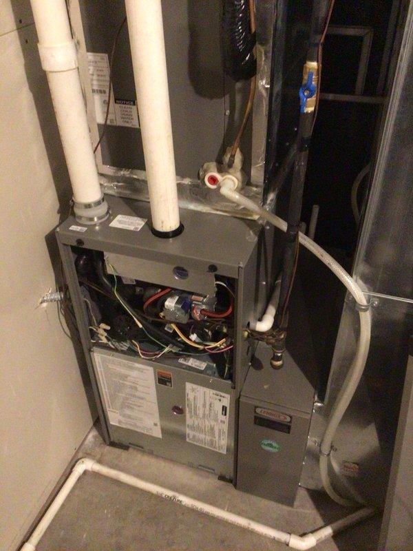 Completed routine heating maintenance on residential Lennox furnace system as part of Family Rewards Club membership agreement. Performed comprehensive furnace tune-up including cleaning of flame sensor, electrical testing with all readings within manufacturer specifications, and verification of proper unit operation. Replaced air filter and humidifier pad with customer-provided materials, confirmed all hoses were clear and functioning correctly, and verified humidifier operation. System operating properly with no issues identified during inspection.