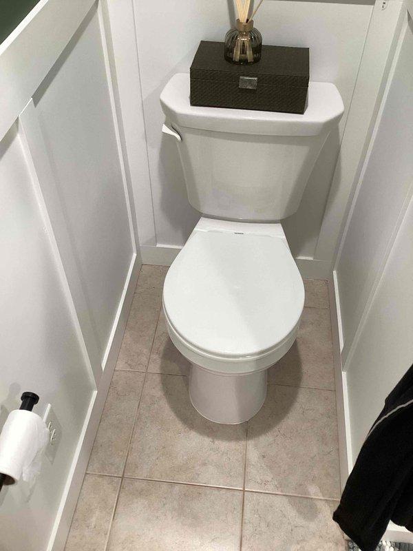 Responded to a callback for a persistently leaking toilet following initial installation and a previous reset attempt. Upon inspection, identified the toilet flange was improperly positioned below the finished floor level, preventing adequate wax ring seal compression. Removed toilet, cleaned existing wax ring residue from flange and toilet base, and installed a flange extender to bring the flange flush with the tile surface. Applied reinforced wax ring with integrated polyethylene funnel for enhanced seal integrity. Reset toilet with proper alignment, torqued closet bolts to manufacturer specifications, reconnected water supply line, and tested for leaks. Verified proper bowl stability and confirmed complete seal with no water discharge at base during multiple flush cycles.