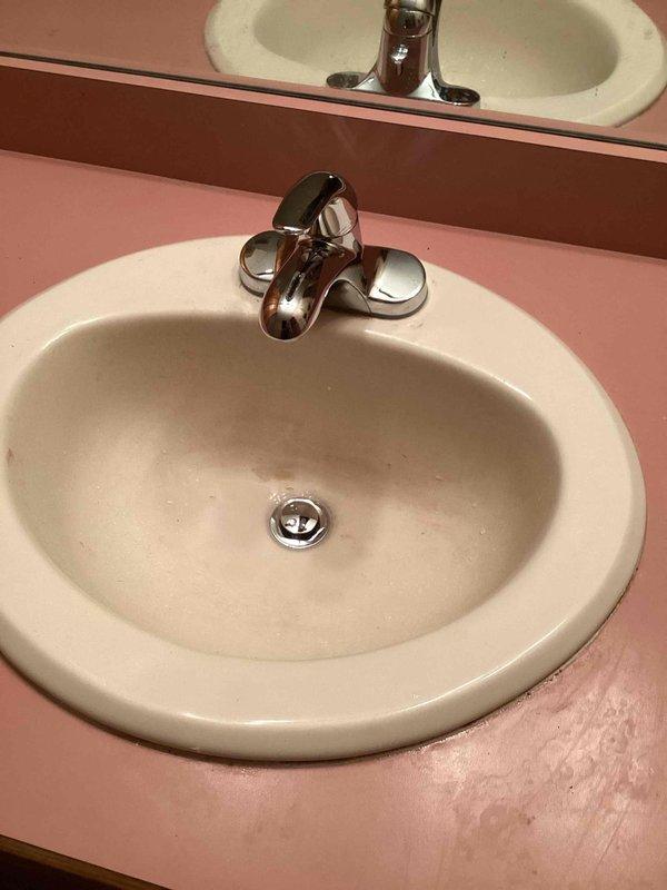 Completed installation of customer-supplied chrome faucet with dual handles on bathroom sink with pink countertop. Installed Badger 5 garbage disposal (1/2 HP, 2-year warranty) in kitchen, replacing existing unit using current electrical and plumbing connections. Installed customer-supplied brushed nickel pull-down kitchen faucet on double-basin stainless steel sink. All fixtures tested for proper operation and checked for leaks upon completion.