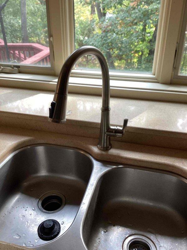 Completed installation of customer-supplied chrome faucet with dual handles on bathroom sink with pink countertop. Installed Badger 5 garbage disposal (1/2 HP, 2-year warranty) in kitchen, replacing existing unit using current electrical and plumbing connections. Installed customer-supplied brushed nickel pull-down kitchen faucet on double-basin stainless steel sink. All fixtures tested for proper operation and checked for leaks upon completion.