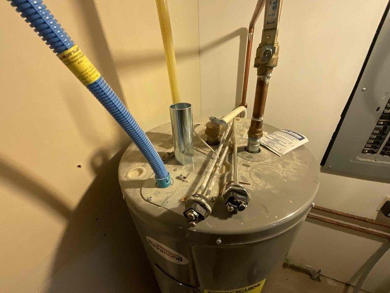 Responded to no hot water call and performed diagnostic inspection of tanked water heater system. Upon arrival, inspected electrical panel and verified proper circuit breaker operation and power supply to the unit. Examined water heater installation including all plumbing connections, pressure relief valve, copper piping, gas supply line with flexible connector, and flue venting components. Assessed overall system configuration and documented existing conditions of the water heater, associated piping, safety devices, and electrical connections to determine cause of no hot water condition and restore proper operation.