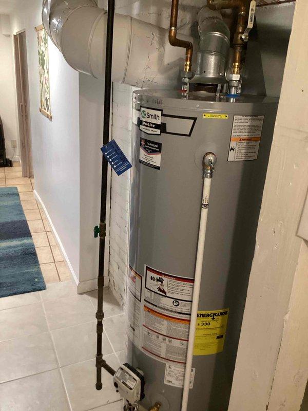 Performed routine maintenance on A.O. Smith tanked water heater installed in residential utility room. Completed full tank flush to remove sediment buildup and ensure optimal performance and longevity of the unit. Inspected all copper piping connections, brass fittings, pressure relief valve, and discharge pipe for proper operation and signs of corrosion or leaks. Verified water temperature settings, examined energy guide labels and safety warnings for visibility and compliance. Tested hot water delivery and confirmed unit is operating within normal parameters. All components including expansion tank, venting system, and plumbing connections found to be in good working condition with no issues identified.