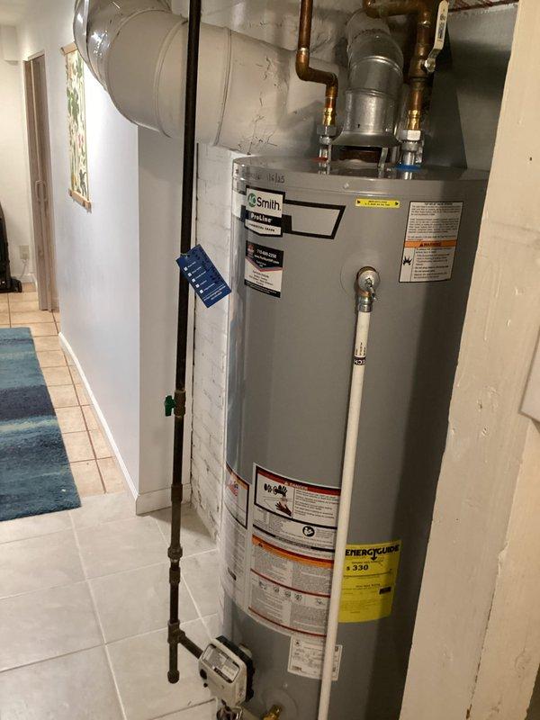 Performed routine maintenance on A.O. Smith tanked water heater installed in residential utility room. Completed full tank flush to remove sediment buildup and ensure optimal performance and longevity of the unit. Inspected all copper piping connections, brass fittings, pressure relief valve, and discharge pipe for proper operation and signs of corrosion or leaks. Verified water temperature settings, examined energy guide labels and safety warnings for visibility and compliance. Tested hot water delivery and confirmed unit is operating within normal parameters. All components including expansion tank, venting system, and plumbing connections found to be in good working condition with no issues identified.