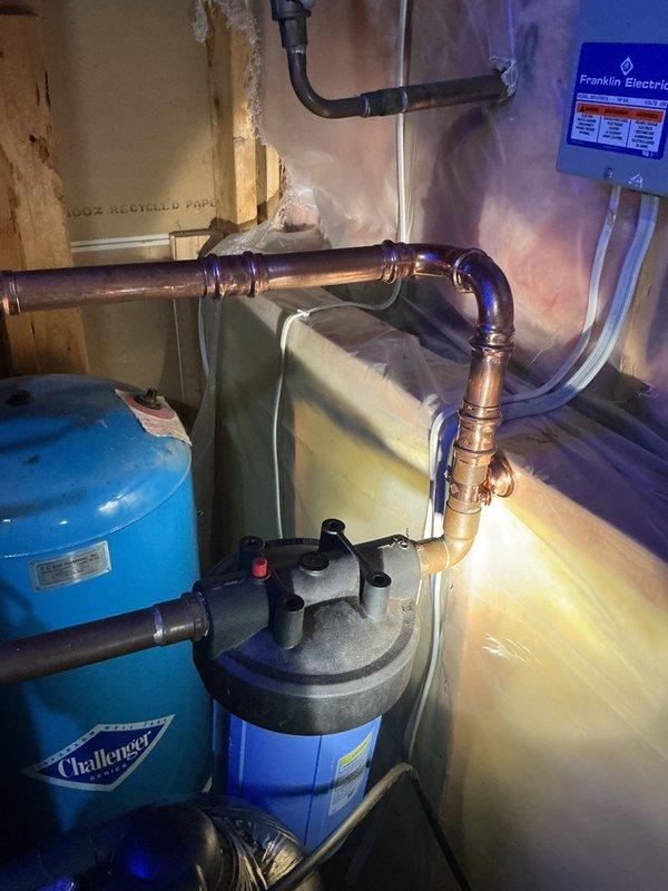 Responded to callback for water softener leaking following previous disconnect/reconnect service performed for HVAC installation. Upon inspection, identified the water filter as the source of the leak rather than the softener itself. Replumbed the filter housing and connections, verified all fittings were properly sealed, and conducted pressure test to confirm leak was completely resolved with no further dripping or moisture detected.