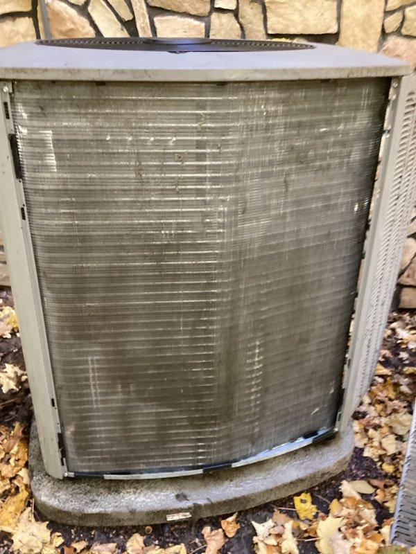Responded to service system alert with Alarm ID 411 indicating outdoor unit low pressure switch strikes lockout. Upon arrival, system was non-operational with thermostat displaying error codes causing air conditioning lockout. Performed diagnostic inspection of thermostat, zone control system, and furnace components. Identified heavily clogged condenser coil obstructed with pollen accumulation as primary cause of system failure. Cleared all error codes from thermostat and control board. Thoroughly cleaned outdoor condenser coil to restore proper airflow and heat exchange capacity. Cycled system through multiple operational sequences to verify proper function across all zones. Set all zones to off position and confirmed system returned to normal operation with no recurring errors or lockouts.