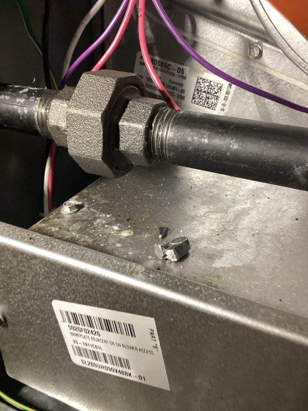 Responded to Alarm ID 38 error on Lennox iComfort S40 thermostat with SL280 furnace not heating. Diagnosed non-operational inducer motor and disassembled unit to find metal debris from broken flue connector jamming the inducer wheel. Removed metal fragments left from improper installation of flue pipe connection, cleared obstruction, and restored inducer operation. Performed system test in all modes including cooling, heat pump, and furnace heating to verify proper operation. Reset furnace control board, cleared error codes, and confirmed system returned to normal operation with all functions working correctly.