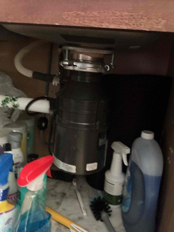 Responded to service call for non-functioning garbage disposal unit (InSinkErator Badger model #5-84A) in residence built in 2015. Upon arrival, confirmed disposal was jammed due to broken glass lodged in the grinding chamber. Disconnected power supply and removed disposal unit from sink mounting assembly. Disassembled unit and extracted all broken glass fragments from grinding chamber and impeller assembly. Thoroughly cleaned internal components to ensure no remaining glass shards. Reinstalled disposal unit, reconnected plumbing connections and electrical supply, and successfully tested operation. Unit reset and restored to full working condition.