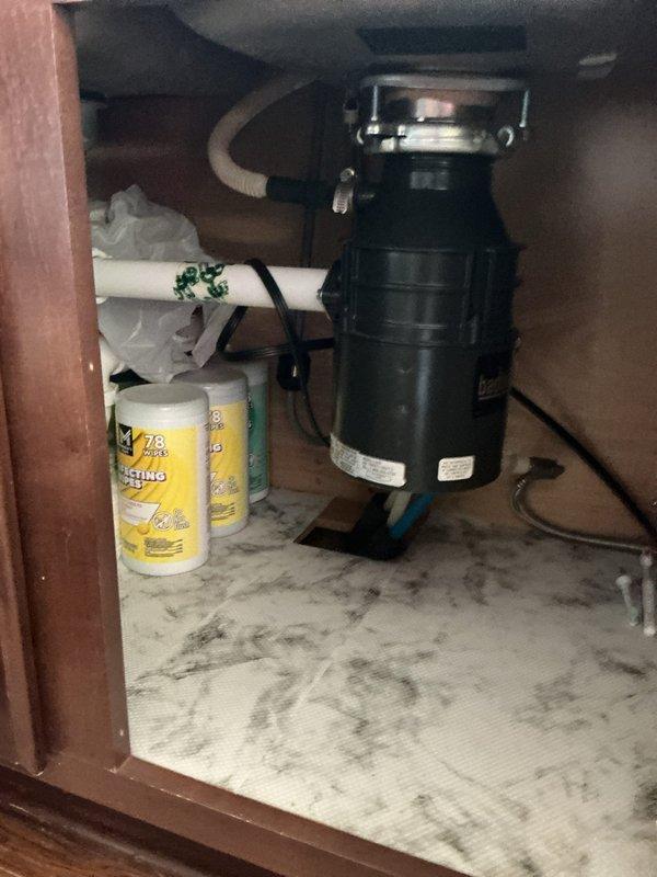 Responded to service call for non-functioning garbage disposal unit (InSinkErator Badger model #5-84A) in residence built in 2015. Upon arrival, confirmed disposal was jammed due to broken glass lodged in the grinding chamber. Disconnected power supply and removed disposal unit from sink mounting assembly. Disassembled unit and extracted all broken glass fragments from grinding chamber and impeller assembly. Thoroughly cleaned internal components to ensure no remaining glass shards. Reinstalled disposal unit, reconnected plumbing connections and electrical supply, and successfully tested operation. Unit reset and restored to full working condition.