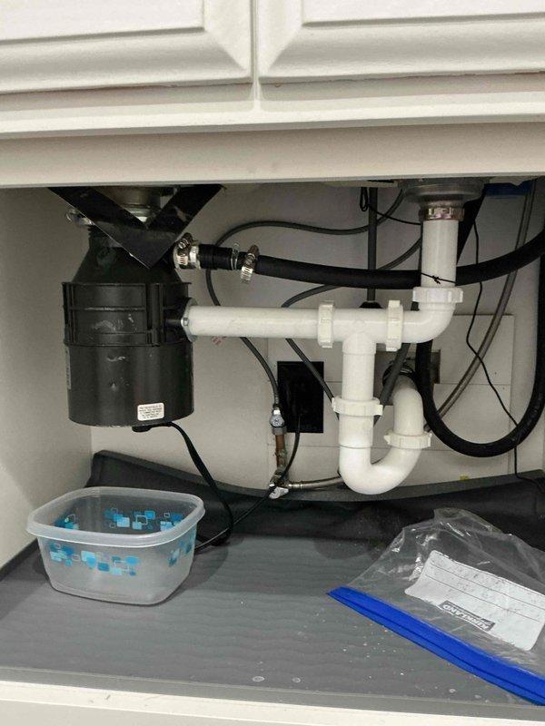 Responded to service call for reported garbage disposal leak. Upon diagnostic inspection, unable to replicate or locate any active leaking from the existing disposal unit. Customer requested full replacement of the garbage disposal regardless of diagnostic findings. 

Removed existing garbage disposal unit from mounting assembly and disconnected all electrical and plumbing connections. Installed new GrindSmart garbage disposal, ensuring proper alignment with sink mounting flange and secure attachment to drain assembly. Connected disposal to existing P-trap configuration using appropriate PVC drainage components. Verified all connections were properly sealed and torqued to manufacturer specifications.

Restored electrical power to unit and conducted operational testing of new garbage disposal. Ran disposal through multiple cycles with water flow to verify proper grinding function and drainage. Performed thorough leak inspection of all connection points including mounting flange, dischar