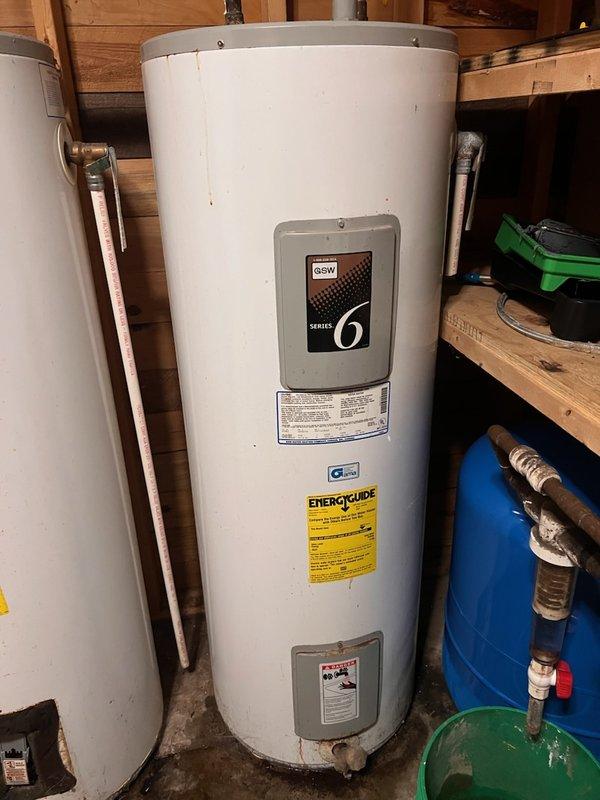 Removed and disposed of two aging, leaking 26-year-old electric tank water heaters that were short-cycling and delivering only about 10 minutes of hot water. Since the whirlpool tub they served is out of service, the system was consolidated to a single new 50-gallon electric water heater, which was installed, connected, and tested for proper heating and leak-free operation.