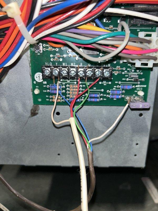 Responded to a no-heat complaint on a furnace over 10 years old and found the W1 heat-call wire loose at the control board terminal, preventing the heat demand signal and causing the unit to blow cold air. Re-stripped and re-secured all low-voltage control wires at the board terminals, and verified proper terminal connections. Likely cause was continuous vibration from the thermostat being left in "fan on" mode, which loosened the connections over time.