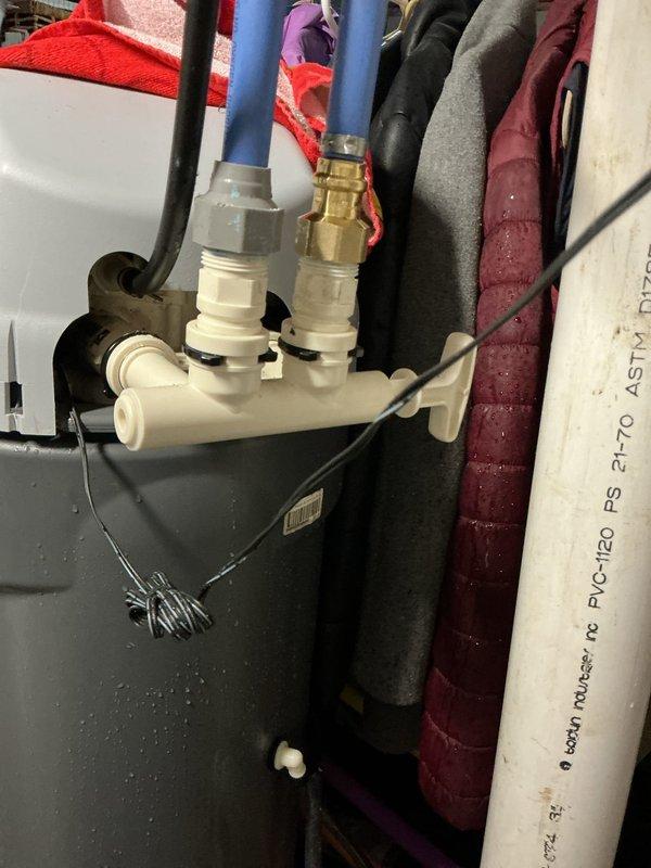 Diagnosed a water leak at the water softener's inlet/outlet manifold and installed a bypass connection to isolate the unit and stop the leak. Repaired the affected connections, restored water flow to the system, and verified that all fittings were secure and dry.