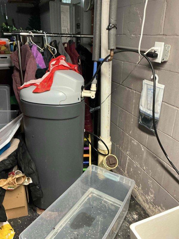 Diagnosed a water leak at the water softener's inlet/outlet manifold and installed a bypass connection to isolate the unit and stop the leak. Repaired the affected connections, restored water flow to the system, and verified that all fittings were secure and dry.
