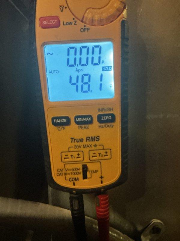 Performed a full maintenance tune-up on a 15-year-old Bryant forced air furnace, including electrical testing of components with a clamp multimeter and inspection of the cabinet interior. The heat exchanger passed inspection, but the draft inducer motor/housing area was flagged as a suspected leak, with rust and corrosion staining observed on the cabinet floor beneath the inducer assembly. Recommended further evaluation of the inducer assembly to confirm the leak and prevent continued corrosion.