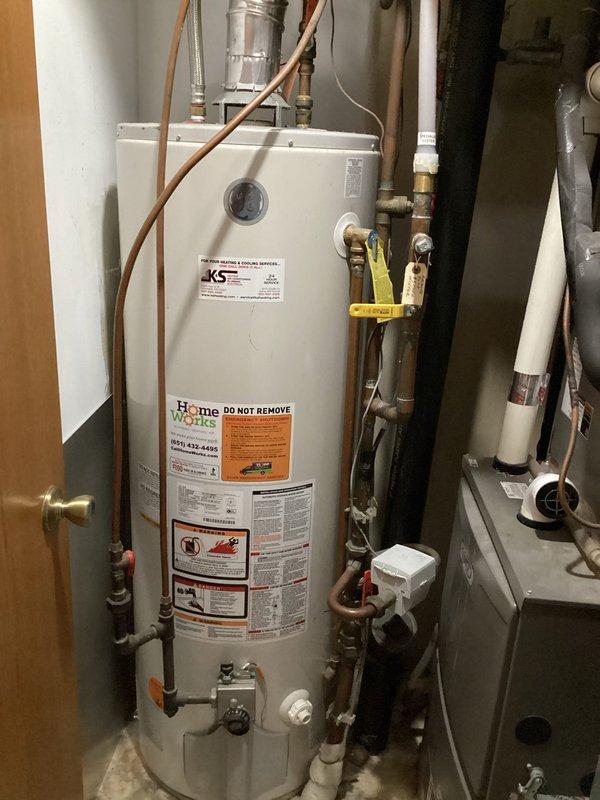 Performed a member plumbing inspection and evaluated the gas water heater, which is well past its serviceable life (10+ years) and recommended for replacement. Noted corrosion and verdigris buildup on copper supply piping, valves, and fittings in the utility area, and assessed the slow-draining downstairs bathroom sink for drain restriction.